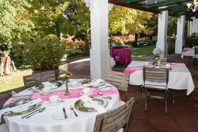 a table set up for a party on a patio at Le Manoir de Brendel in Franschhoek