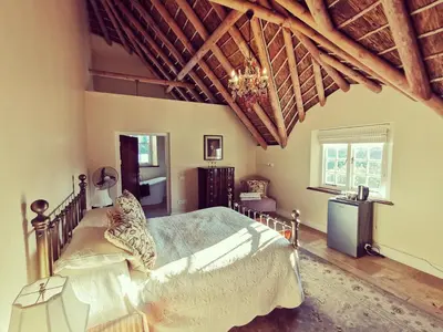 a bedroom with a bed and a wooden ceiling at Gemoedsrus Farm in Stellenbosch