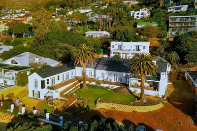 an aerial view of a house with palm trees at Manor on the Bay in Gordonʼs Bay