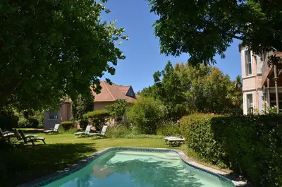 a swimming pool in the yard of a house at Medindi Manor in Cape Town