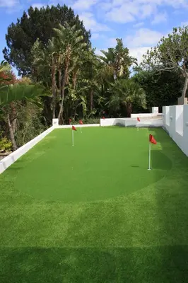 a golf course with green grass and red flags on it at Morgen Guesthouse Somerset West in Somerset West