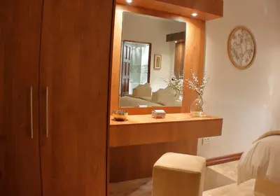 a bedroom with a dresser and a mirror at Keret Accommodation in Bellville