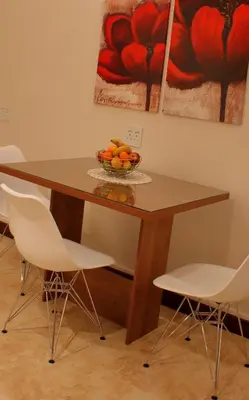 a wooden table with a bowl of oranges on it at Keret Accommodation in Bellville