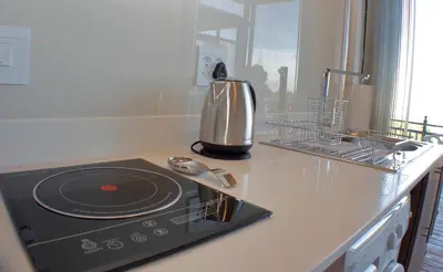 a kitchen with a counter top with a stove top oven at Keret Accommodation in Bellville