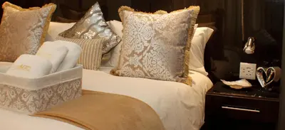 a bed with pillows and towels on it at Keret Accommodation in Bellville