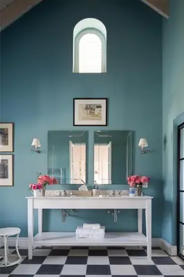 a bathroom with a white sink and a blue wall at La Cotte Orchard Cottages in Franschhoek