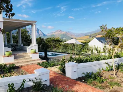 a house with a view of the mountains at La Cotte Orchard Cottages in Franschhoek