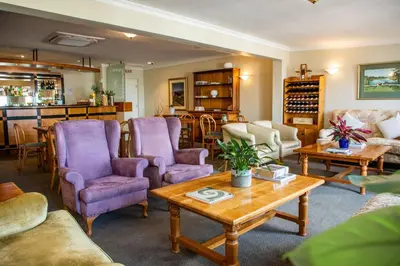 a living room with purple chairs and a table at Zevenwacht Country Inn in Kuilsrivier