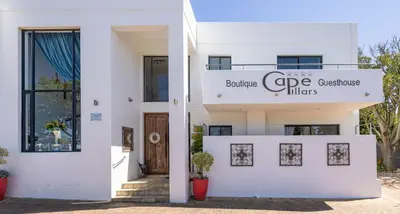 a white house with a sign for the entrance to the building cape customs offices at Cape Pillars Boutique Hotel in Durbanville