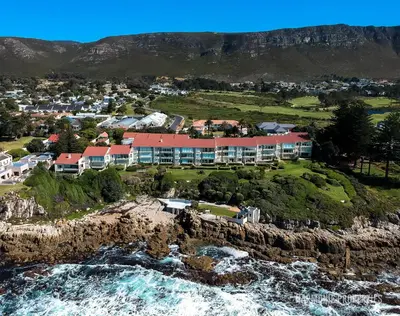an aerial view of a resort on a cliff next to the ocean at Bayview Bliss in Hermanus