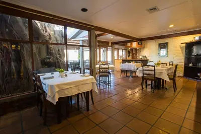 a restaurant with tables and chairs in a room at Damas Guest Farm in Worcester