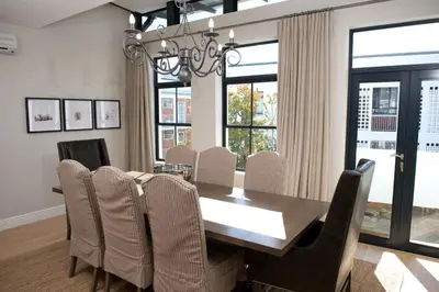 a dining room with a table and chairs at 14 On Louw in Stellenbosch