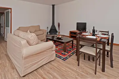 a living room with a couch and a table at La Galiniere Guest Cottages in Franschhoek