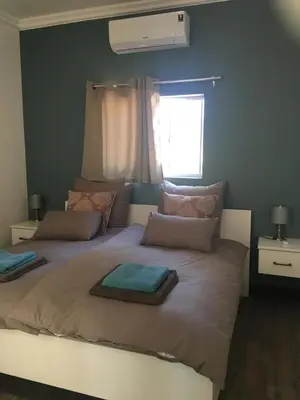 a bedroom with two beds and a window at Sweetwater Guesthouse in Wellington