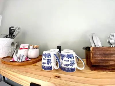 a counter with three blue and white mugs on it at Groenvlei Guest Farm in Kuilsrivier