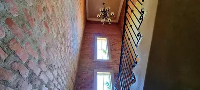 a hallway with two windows and a brick wall at Sandmartins in Suider-Paarl