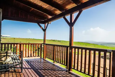 a porch with a bench and a view of a field at Anna Beulah Farm in Durbanville