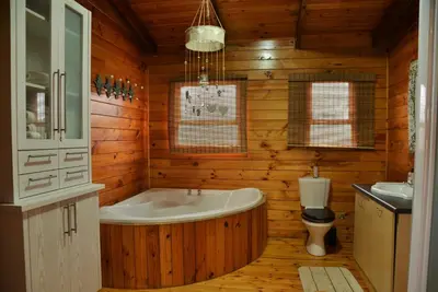 a wooden bathroom with a tub and a toilet at Anna Beulah Farm in Durbanville