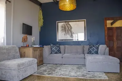 a living room with a couch and a chair at Anna Beulah Farm in Durbanville