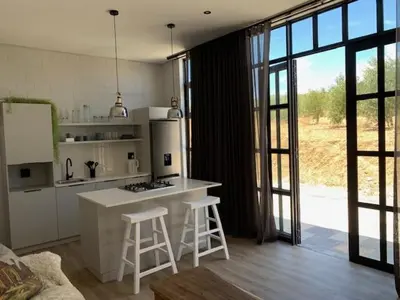a kitchen with a counter and stools in a room at Anna Beulah Farm in Durbanville