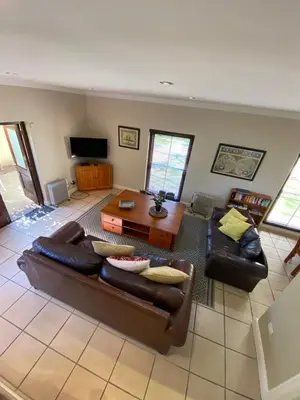 a living room with a couch and a table at @Leisure Guest Suite in Stellenbosch