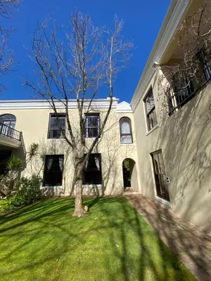 a building with a tree in the yard at @Leisure Guest Suite in Stellenbosch