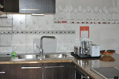 a kitchen with a sink and a counter top at Pelican Place Guest Cottages in Durbanville