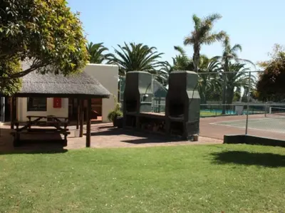 a building with a pavilion with a tennis court at Amies Self-Catering Apartments in Panorama