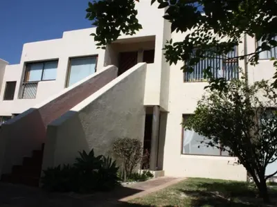 a white building with a staircase in front of it at Amies Self-Catering Apartments in Panorama