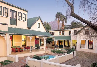 a house with a swimming pool in the yard at Evergreen Lodge in Stellenbosch