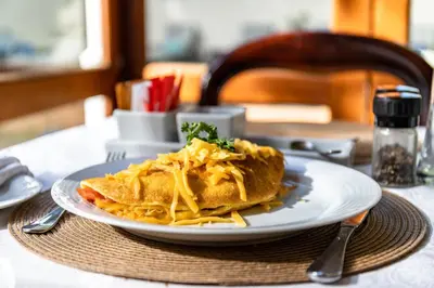 a plate of food with pasta on a table at Evergreen Lodge in Stellenbosch