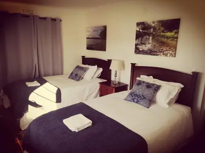 a hotel room with two beds with towels on them at Induku in Stellenbosch
