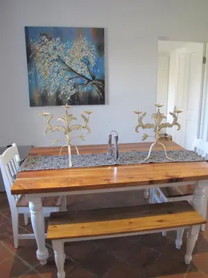 a dining room table with a sink and a painting at Induku in Stellenbosch