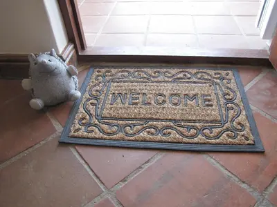 a welcome mat in front of a door with the word welcome at Induku in Stellenbosch