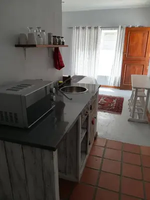 a kitchen with a counter top with a microwave at Annika Self-catering and B&B in Stellenbosch