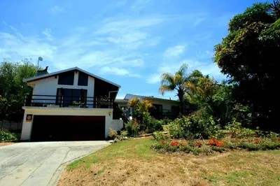 a house with a garage in front of a yard at Annika Self-catering and B&B in Stellenbosch