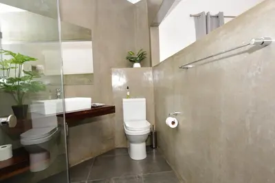 a bathroom with a toilet and a sink at OnQ Accommodation in Bellville