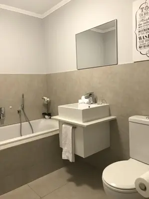 a bathroom with a sink and a toilet and a tub at 131 Yellowwood Ashton Park in Cape Town