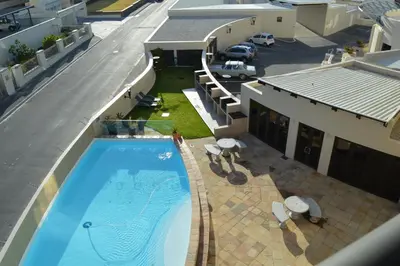 an overhead view of a swimming pool on a building at Ocean View 201A in Strand