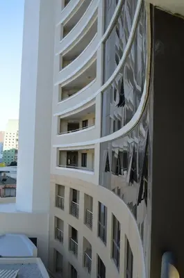 a reflection of a building on the side of a window at Ocean View 201A in Strand