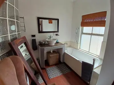 a bathroom with a sink and a bath tub at Ons Stee Bed and Breakfast in Wellington