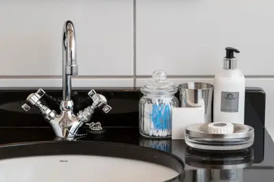 a bathroom counter with a sink and a sink at De Hoek Manor in Stellenbosch
