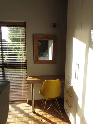 a room with a desk and a chair and a mirror at Live Like a Local: Studio 29 @ 25 Market street in Stellenbosch