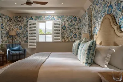 a bedroom with a large bed and a window at Le Quartier Francais in Franschhoek