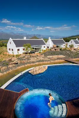 a woman is swimming in a swimming pool at Babylonstoren in Simondium
