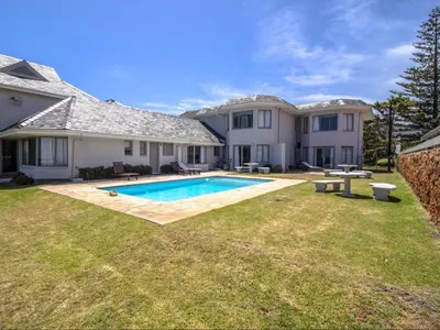 a house with a swimming pool in a yard at Sandbaai Country House in Hermanus