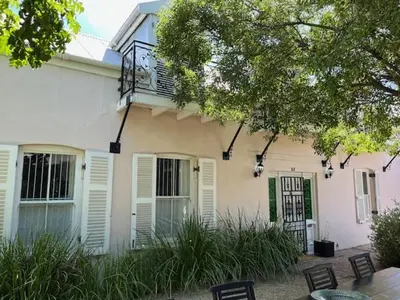 a white house with white windows and a balcony at The Prime Spot Self Catering in Worcester