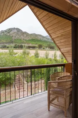 a screened porch with a view of a mountain at Heuwelsig Farm Cottages in Franschhoek