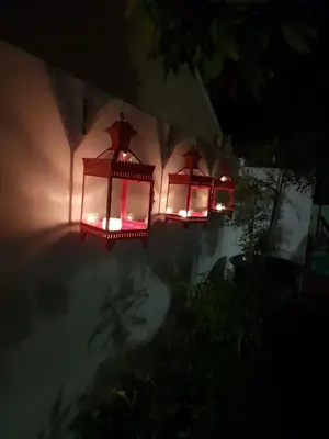 two lights on the side of a house at night at Bleu Cobalt Cottage in Franschhoek
