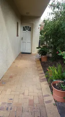 a walkway leading to a door of a house at Durbanville Place - 3 bedroom apartment in Durbanville